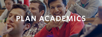 A group of students sitting in a classroom, with the words "Plan Academics" overlaid on the image. One person in a red sweater is smiling.